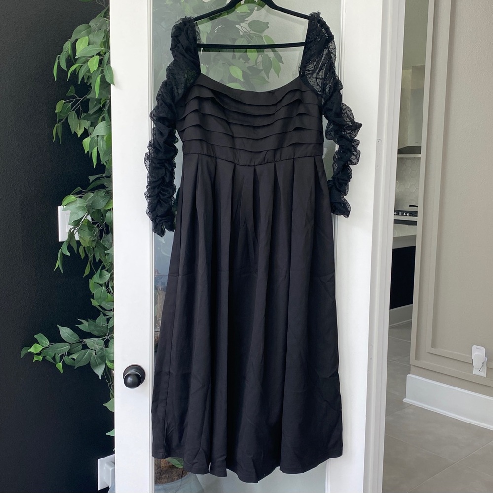 Black dress with ruffle long sleeves and lace details